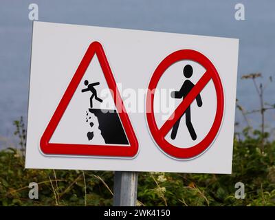 large warning signs for the danger of falling from a height and the prohibition to approach the ravine Stock Photo