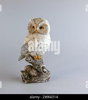 Ceramic owl figurine on a white background. Selective focus. Copy space. Stock Photo