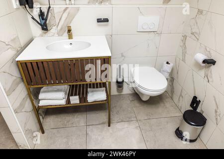 Stunning interior perspective of hotel restroom in light tones, equipped with all amenities for guests. Curacao. Stock Photo