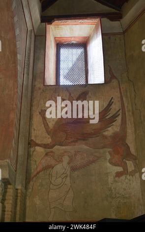 Spain, Toledo. Church of San Román. Built in Mudejar style in the 13th century. Mural paintings on the north wall. Depiction of a dragon being speared, a scene interpreted as St Michael's fight against the dragon. Stock Photo