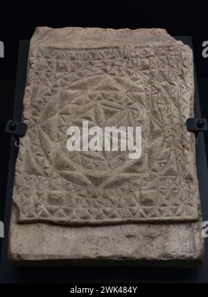 Plaque or brick decorated in relief with religious motif. Chrismon with geometric decoration. Baked clay. 4th-5th centuries. Provenance unknown. Museum of Visigoth Councils and Culture. Toledo, Castile-La Mancha, Spain. Stock Photo