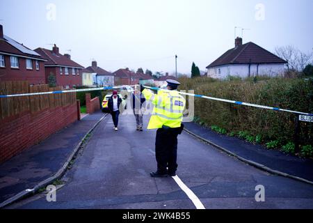 Police at the scene in Blaise Walk, in Sea Mills, Bristol, where a woman has been arrested on suspicion of murder after three children were found dead at a property. Picture date: Sunday February 18, 2024. Stock Photo