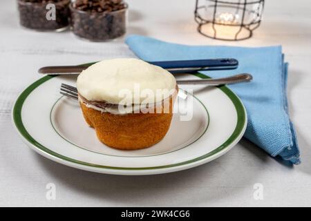 Cinnamon Bun, coffee beans, lamp and coffee beans on wooden table Stock Photo