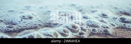 Close up sea water with little bubbles photo. Surface with selective focus in the foreground and blurry background. Mediterranean sea, nautical backgr Stock Photo