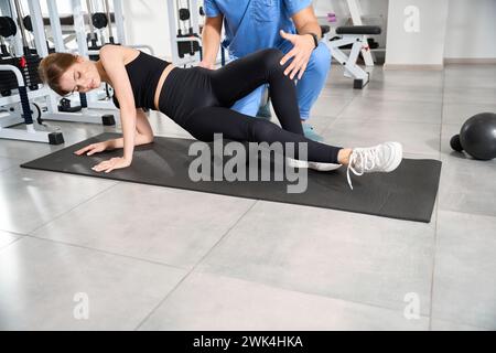 Kinesiologist works with a patient in the hall Stock Photo