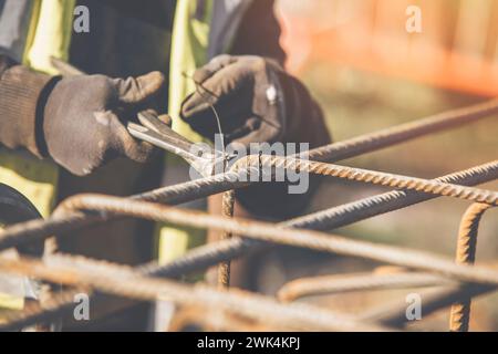 Construction worker steel fixer working at the building  site close-up Stock Photo
