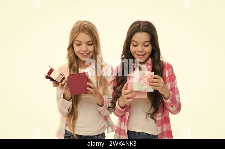 Intriguing moment. Small girls open holiday present. Children excited cheerful faces hold presents. Opening gifts. Perfect present for teen. Birthday Stock Photo