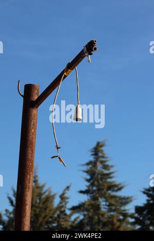 Vintage charm. Metal rusty post and hanging cable light fixture without bulb. Stock Photo