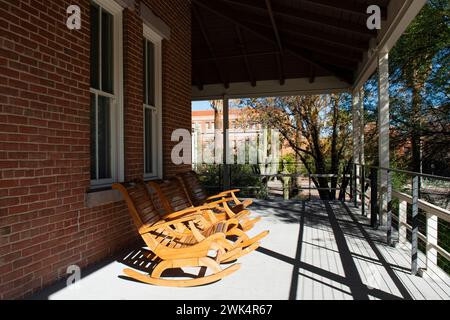 Three Rocking chairs on the porch of Old Main which once served as the only building on the University of Arizona campus Tucson with six teachers Stock Photo