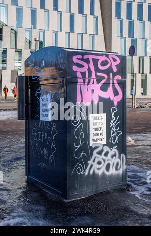 Stop Nazis. Pink graffiti on a public waste container by Dallapénpuisto in Vallila district of Helsinki, Finland. Stock Photo