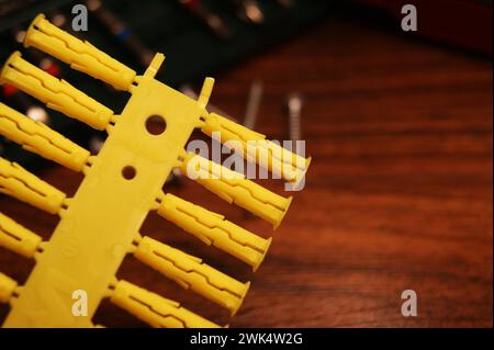 Close-up of yellow plastic dowels. Installation and construction. Stock Photo