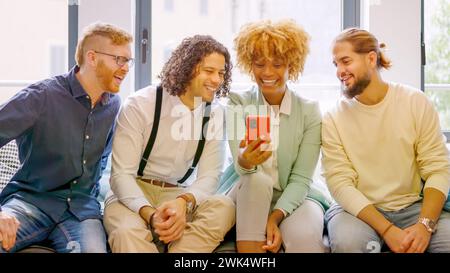 Coworkers using phone sitting relaxed during a break Stock Photo