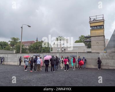 Tour group on the Bernauer Strasse preserved section of the Berlin Wall opposite the Documentation Center, Berlin, Germany. Stock Photo