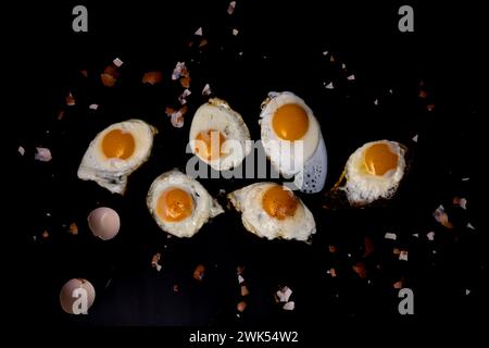 Fried eggs with shells on a black background Stock Photo