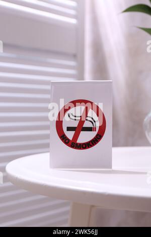 No Smoking sign on white table indoors Stock Photo