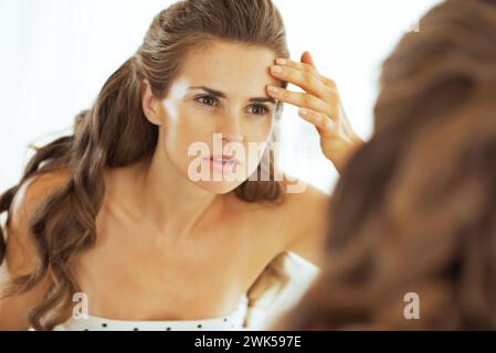 young woman checking facial skin condition Stock Photo