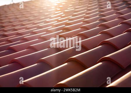 Orange colored classic corrugated roof tiles, shingles, close up texture background with a creative perspective Stock Photo