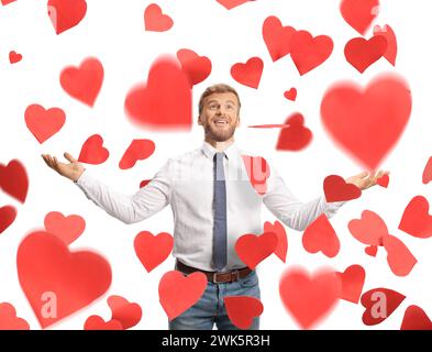 Excited businessman under red falling hearts isolated on white background Stock Photo