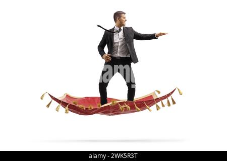 Businessman flying on a magic carpet isolated on white background Stock Photo