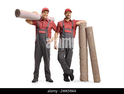 Male workers in uniforms with carpets isolated on white background, carpet cleaning service Stock Photo