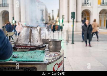 Roasted chestnuts sold on streets of Lisbon, Stand with roasted hazelnuts for sale in Portugal against blurred background Stock Photo