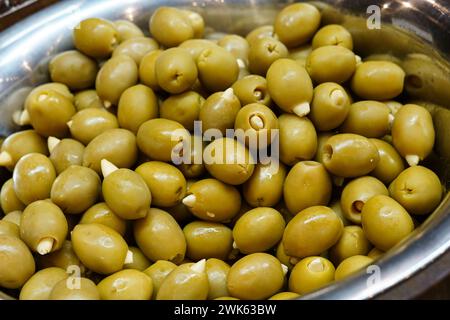 Green olives in a silver bowl. Stock Photo