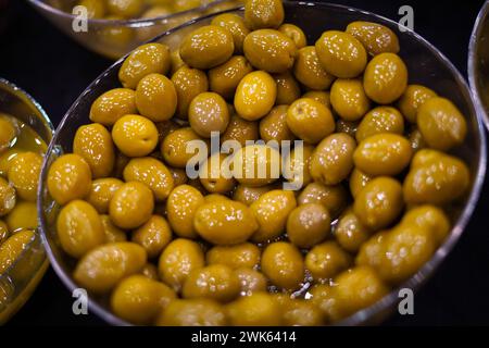 Green olives in a silver bowl. Stock Photo