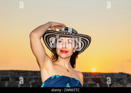 Beautiful woman wearing the traditional Colombian hat called Sombrero Vueltiao at the historical walls of Cartagena de Indias Stock Photo