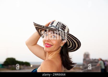 Beautiful woman wearing the traditional Colombian hat called Sombrero Vueltiao at the historical streets of the Cartagena de Indias walled city Stock Photo