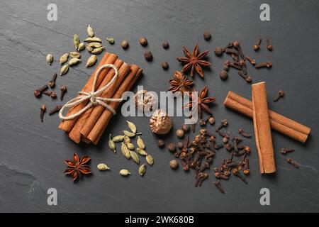 Different spices on dark gray textured table, flat lay Stock Photo