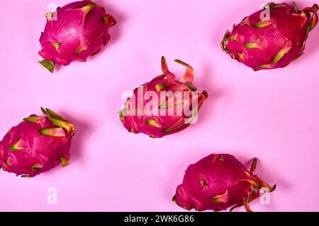 Red dragon fruit Set with appetizing serving Isolated on pink background. Top view, hand Stock Photo