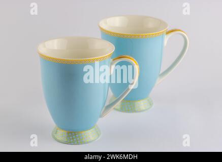 Two blue and gold tea or coffee cups isolated on white background Stock Photo