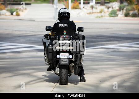Fullerton, California, USA - September 27, 2023: A motorcycle mounted police officer monitors a street. Stock Photo