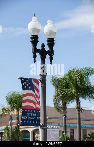 Westminster, California, USA - October 1, 2023: Afternoon light shines on city pole banners in the heart of Little Saigon. Stock Photo