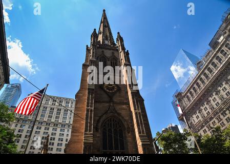 The Trinity Church seen from Wall Street in Lower Manhattan - New York City, USA Stock Photo