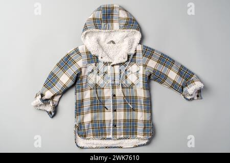 Warm baby coat for boys on gray background top view Stock Photo
