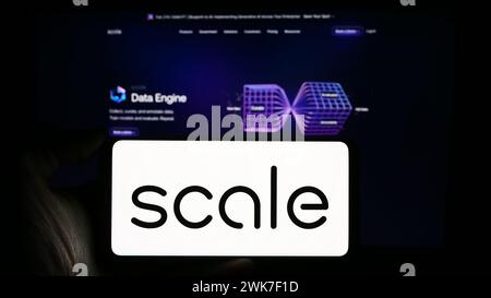 Person holding cellphone with logo of US artificial intelligence company Scale AI Inc. in front of business webpage. Focus on phone display. Stock Photo