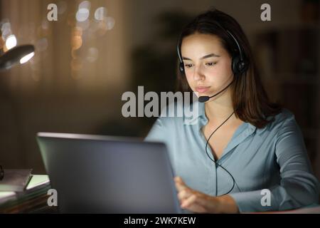 Tele operator working online in the night at home Stock Photo