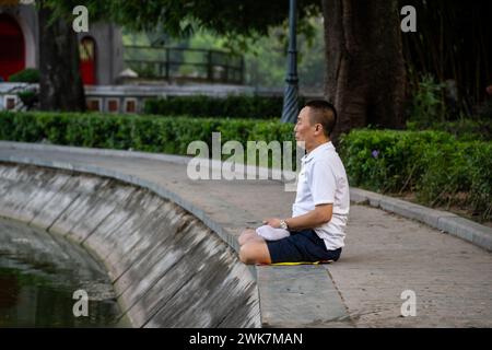 Man doing early morning exercises around Hoan Kiem Lake in Hanoi, Vietnam Stock Photo