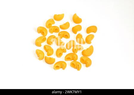 Short ribbed pasta made from durum wheat lies on a white background. Stock Photo
