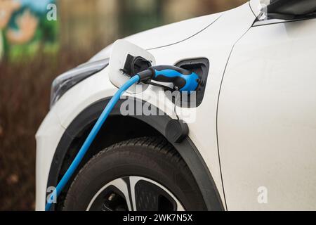 The charging cable is in the electric car Stock Photo