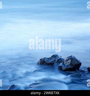 Blurred water around wet stone Stock Photo