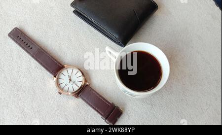 Photo of leather wallet, black coffee and watch on white background Stock Photo