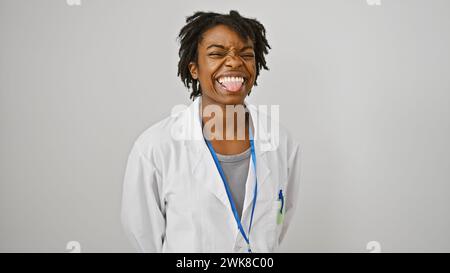 A cheerful young black woman with dreadlocks, wearing a lab coat, posing against a white background, exuding confidence and professionalism. Stock Photo