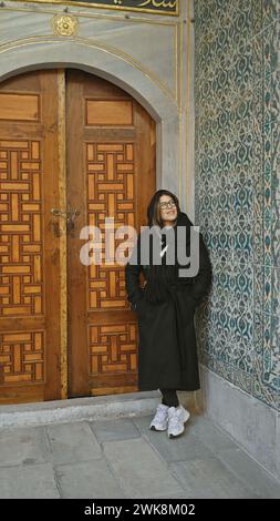 Adult woman exploring the historic topkapi palace in istanbul, showing tourism, culture, and architecture. Stock Photo