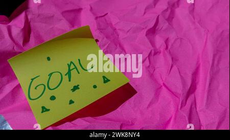 Photo of business and money themed object with text in the note that says 'Goal' Stock Photo