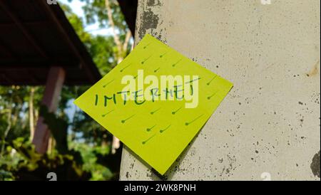 Text with the words "Internet" on a note posted on the wall Stock Photo