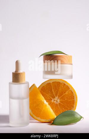 Various cosmetic products with citrus slices and leaves, cosmetic concept with vitamin c and fruit acids. Unbranded package. Stock Photo