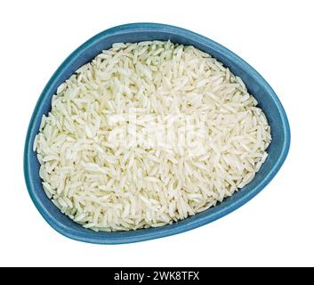 Raw rice in irregular shaped ceramic bowl isolated on white. Top view Stock Photo