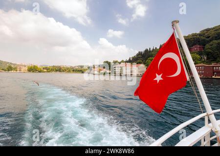 istanbul, turkey - 18 aug 2015: turkish flag on the back of the boat. wonderful view of the eastern shore of bosporus Stock Photo